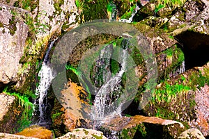 Nature background with big stones and waterfall