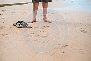 Nature background close up leg of men standing alone on beach wi