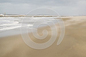 Nature background featuring sand gone with wind in summer windy day on North Sea coast near the Hague in the Netherlands