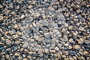 Nature background from gray sea pebbles. Sandy and rocky texture.