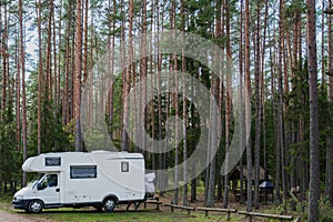 Nature camping on Lake Peipus in autumn. Car, mobile home in a pine forest