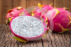 Nature can be pretty weird sometimes, Dragon-fruit are nutritious tropical fruit That way your fruits setup on wooden background. photo