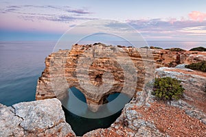 Nature celebrates Valentines Day with the symbol of love carved by nature. Algarve, Portugal.  Seascape of romantic scenario. Hear