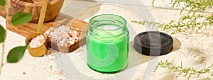 Nature composition with aromatic candle in jar. Mockup soy wax candle on wooden board in natural style. Scented handmade candle