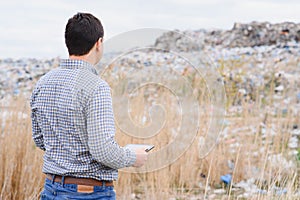 Nature conservation concept. A man studies the pollution of nature. Keeping the environment clean. Ecological problems. Recycling