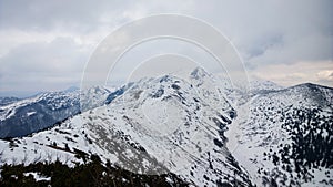 Nature covered in the snow during cold Winter in the country on the hills.