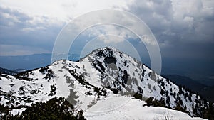 Nature covered in the snow during cold Winter in the country on the hills.