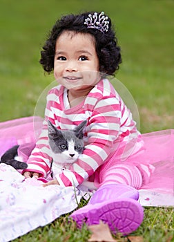 Nature, crown and girl with kitten in a garden on grass on a summer weekend together. Happy, sunshine and portrait of