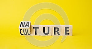 Nature and Culture symbol. Turned wooden cubes with words Culture and Nature. Beautiful yellow background. Business concept. Copy