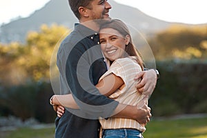 Nature, happy and smile of couple with hug on outdoor date for romance, love and relationship. Man, woman and