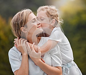 Nature, hugging and child kissing her mother in an outdoor garden for bonding together. Happy, smile and girl kid