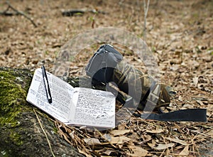 Nature Journal Sketchbook and DSLR camera with wildlife telephoto lens photo