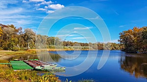 Nature lake autumn reflection with boat. Landscape trees water river background