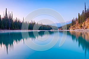 Nature. Landscape at the day time. Lake and forest in a mountain valley. Natural landscape with a sunset sky.