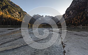 Nature landscape in the dolomites mountains, with long exposure, on a autumn sunny day and sunstars on the sky, Lago di braies, It photo