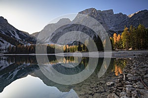 Nature landscape in the dolomites mountains, with long exposure, on a autumn sunny day and sunstars on the sky, Lago di braies, It photo