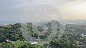 Nature landscape with hill, forest, farm field and morning sky