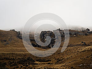 Nature landscape panorama of limestone boulder rocks in dry grass vegetation at Cave Stream in Canterbury New Zealand