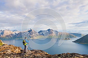 Nature landscape photographer using tripod and dslr camera