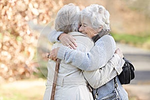 Nature, love and senior friends hugging for support, bonding or care in outdoor park or garden. Happy, smile and elderly