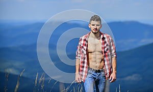 Nature lover. sexy macho man in checkered shirt. cowboy in hat outdoor. countryside concept. farmer on rancho. man on