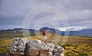 Nature, mountain and man with celebration for hiking, peak and journey with success and freedom outdoor. Trekking, rock