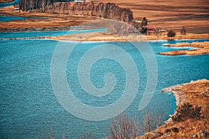 Nature in Norway. Typical scenery from Scandinavia with blue lakes, white ship, trees of birch and red houses