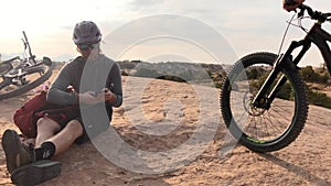 Nature, phone and man relax after mountain bike travel on outdoor ride, desert journey or off road exercise. Bicycle