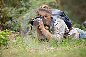 nature photographer shooting macro in field