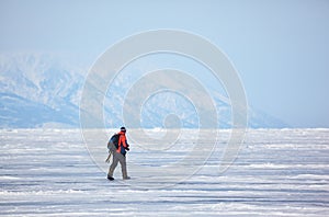 Nature photographer traveling on Baikal Lake in Siberia at winter time