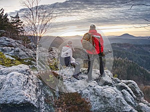 Nature photographers with big camera on tripod on summit