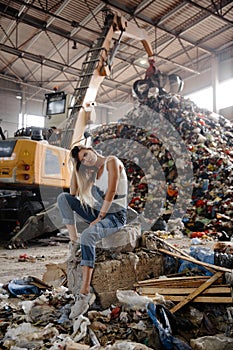 Nature pollution activist at a huge trash dump - Young blonde woman - Looking at all the human waste and plastic in our