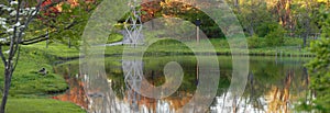 Nature pond with autumn tree reflections