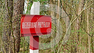 Nature Reserve sign in Poland, signpost of nature conservation area in forest.