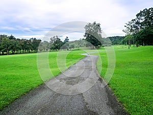 Nature and road. Road path way through green field grass with hill and sky white clouds