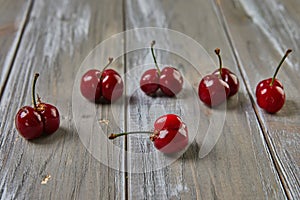 Nature's Oddity: ugly, irregularly shaped cherry stands out against a rustic wooden backdrop