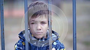 Nature's Resilience: Portrait of a Boy with a Bruised Eye Behind a Fence