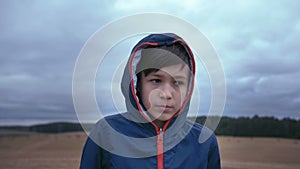 Nature's Wonder: Boy in Hoodie Gazing Surprisingly into Camera