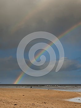 Nature scene with beach, ocean and cloudy sky with rainbow. Rich saturated colors. Nature wonder scene. West of Ireland