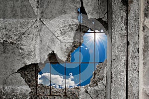 Nature sky view through the hole in a concrete wall