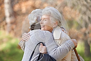 Nature, smile and senior friends hugging for support, bonding or care in outdoor park or garden. Happy, love and elderly