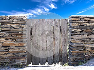 Nature summer landscape. Countryside view and rustic gate in drystone wall in village Cadaces