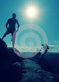 Nature trail runner in t-shirt and shorts watching lazy morning