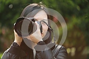 Nature travel photographer woman holding camera in spring park