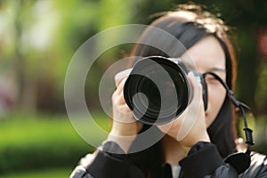 Nature travel photographer woman holding camera in spring park