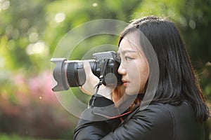 Nature travel photographer woman holding camera in spring park