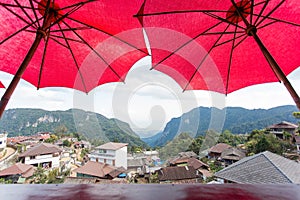 Nature view and native village of Coffee shop at Doi Pha Hee, Chiang Rai in Thailand. It was decorated shop with red umbrella and