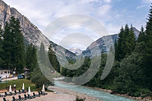 Nature view summer day time. The incredibly beautiful river of turquoise color, Dolomites mountains, Camping Olympia Fiames,