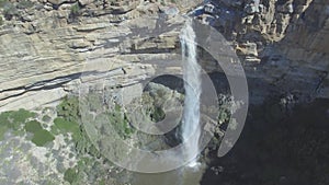Nature, waterfall and drone in mountain with green, landscape and top view of water. Rocky cliff, stream and river in