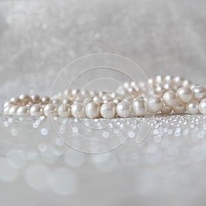 Nature white pearl beads on sparkling background
